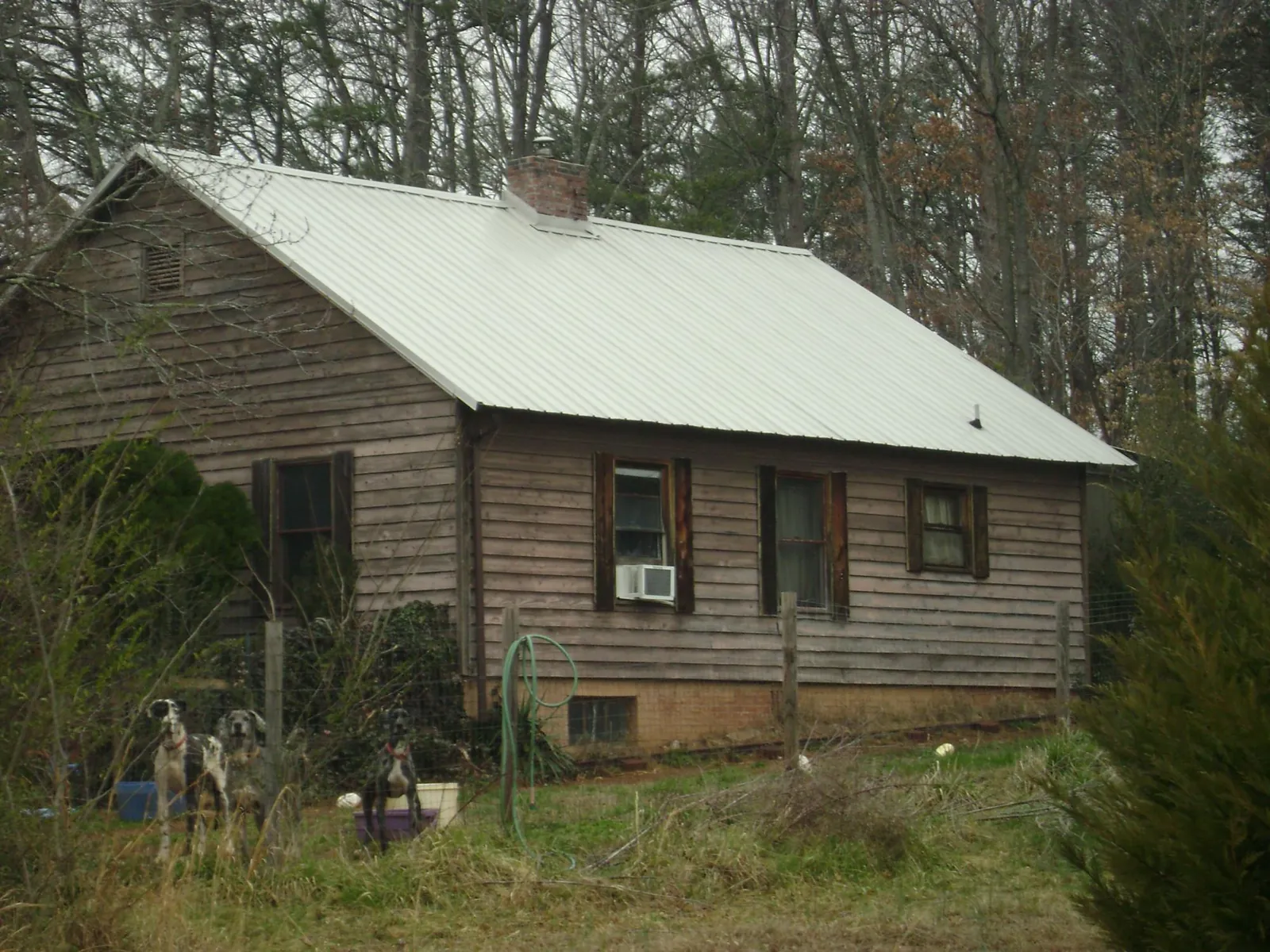 White metal roof on an old wood sided farmhouse, from a Metal Roof Installation job in Danbury